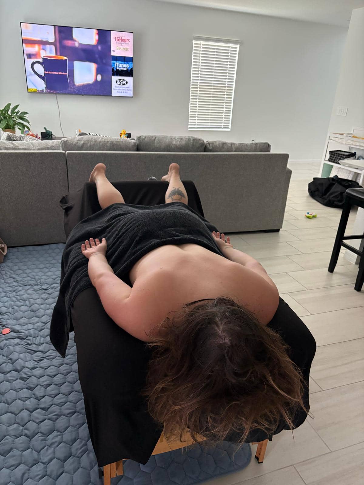 In-home massage therapy session — comfortable setting