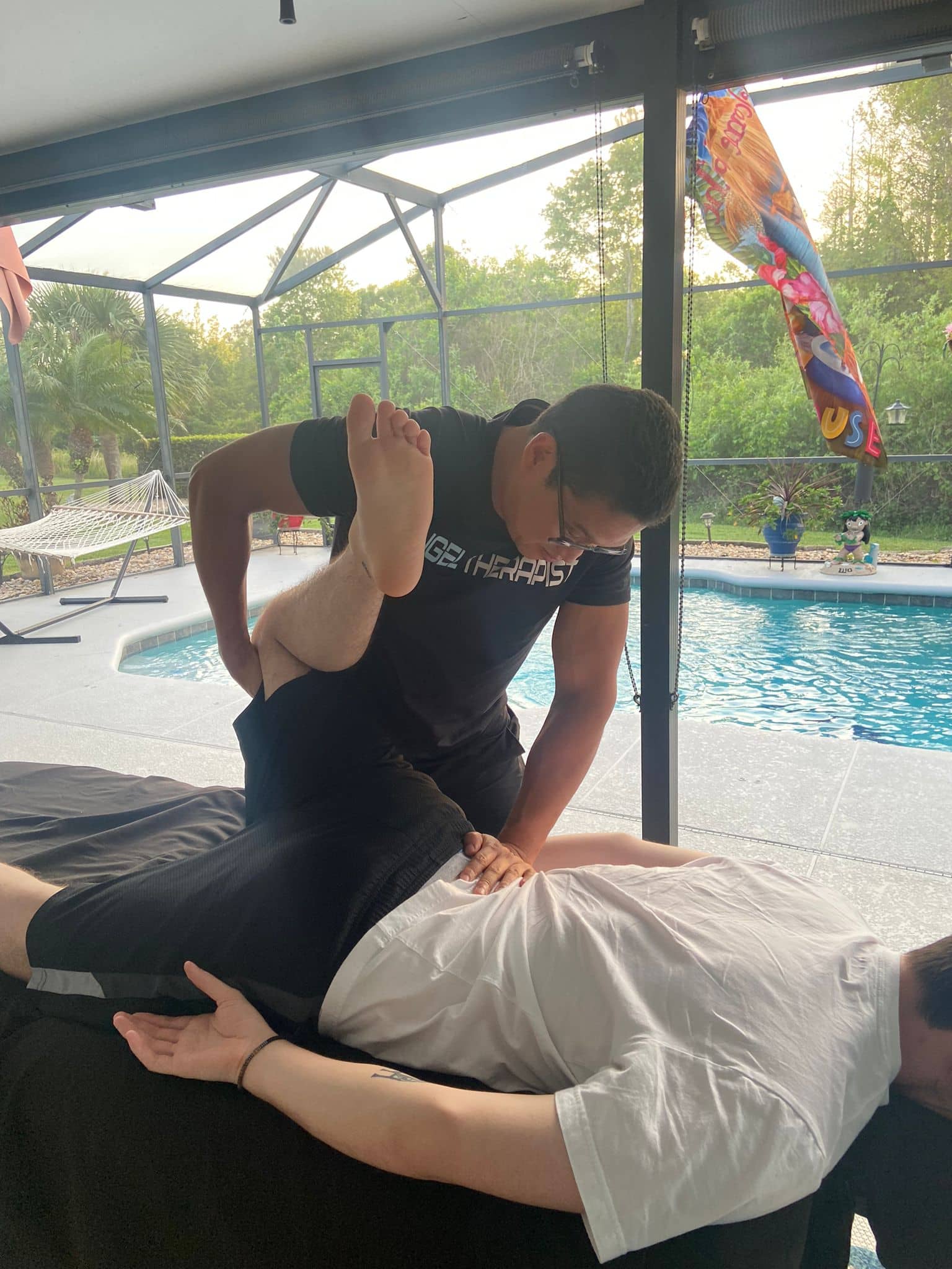 Client relaxing during in-home massage therapy session